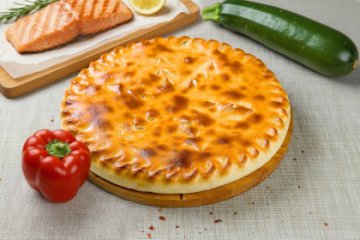 Осетинский пирог с лососем и овощами